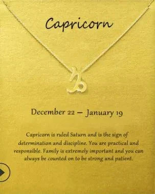 Gold Capricorn Zodiac Pendant Necklace on card displaying dates and characteristics.