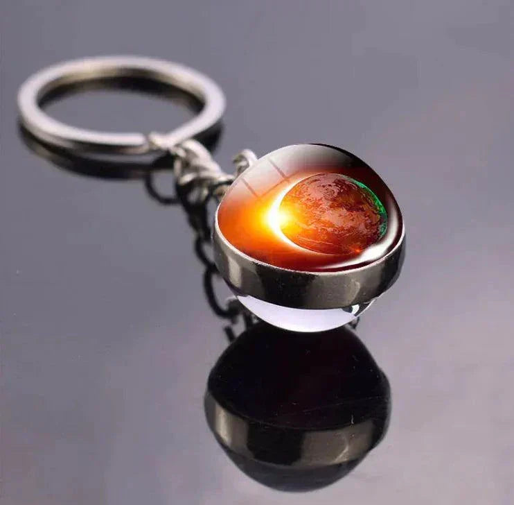 The Planets in The Solar System & Planets Key Ring with round design on reflective surface.