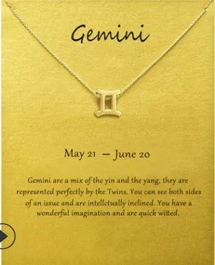 Gemini zodiac sign pendant necklace in gold on a yellow background card.