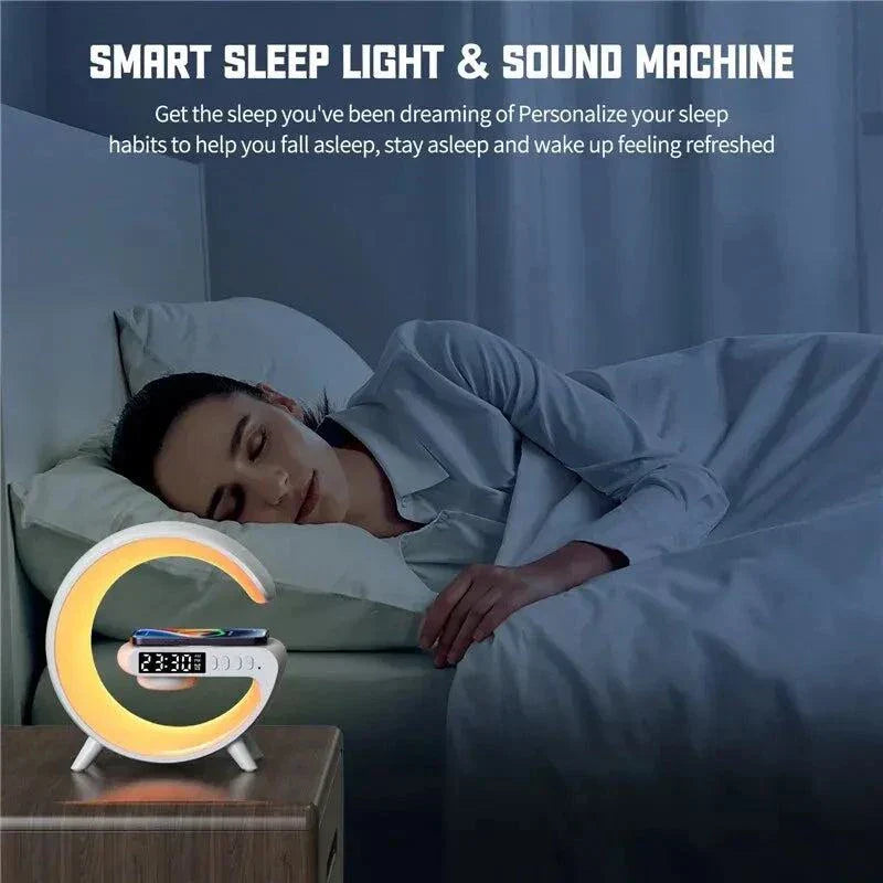 G-Shape LED Lamp with Bluetooth Speaker & Wireless Charger on bedside table by sleeping woman.