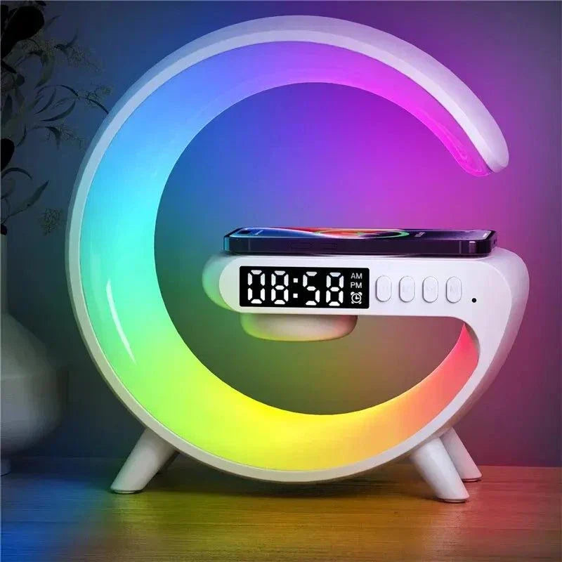 G-Shape LED lamp with Bluetooth speaker and wireless charger, displaying vibrant colors on a wooden table.