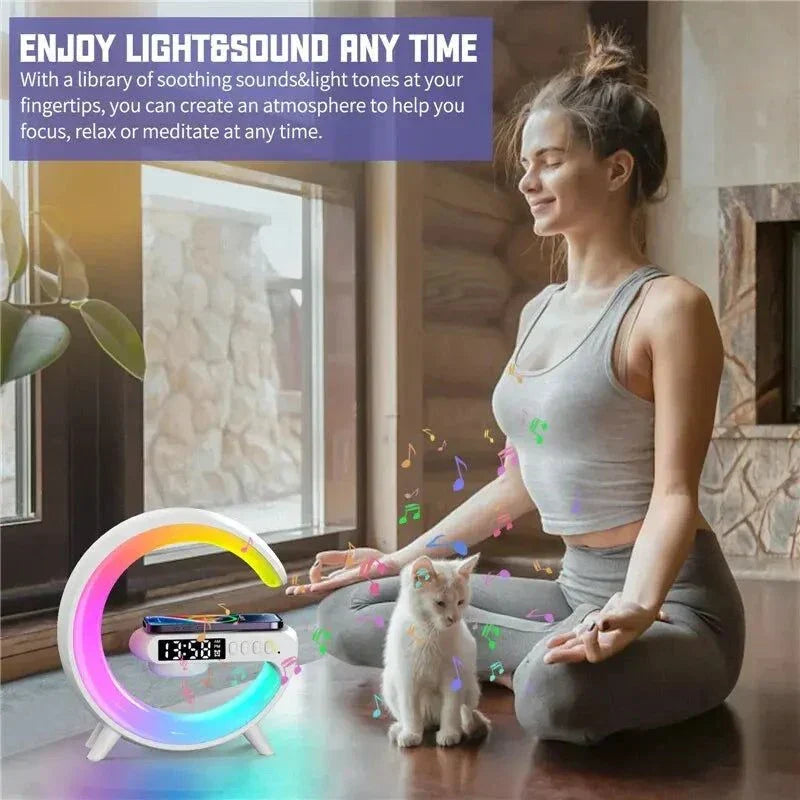 G-Shape LED lamp with Bluetooth speaker and wireless charger in a cozy room setting with a woman meditating nearby.