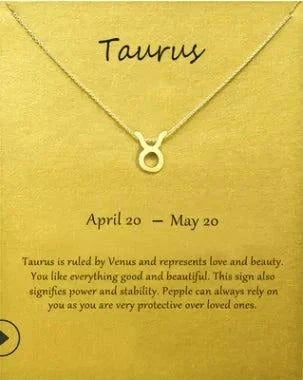 Gold Taurus Zodiac Sign Pendant Necklace on display card with Taurus characteristics and date.