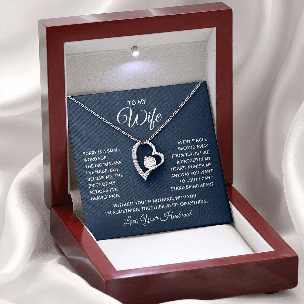 Heart necklace for wife featuring a CZ crystal in a polished heart pendant with smaller crystals, available in white or yellow gold finish, displayed in a luxury box.