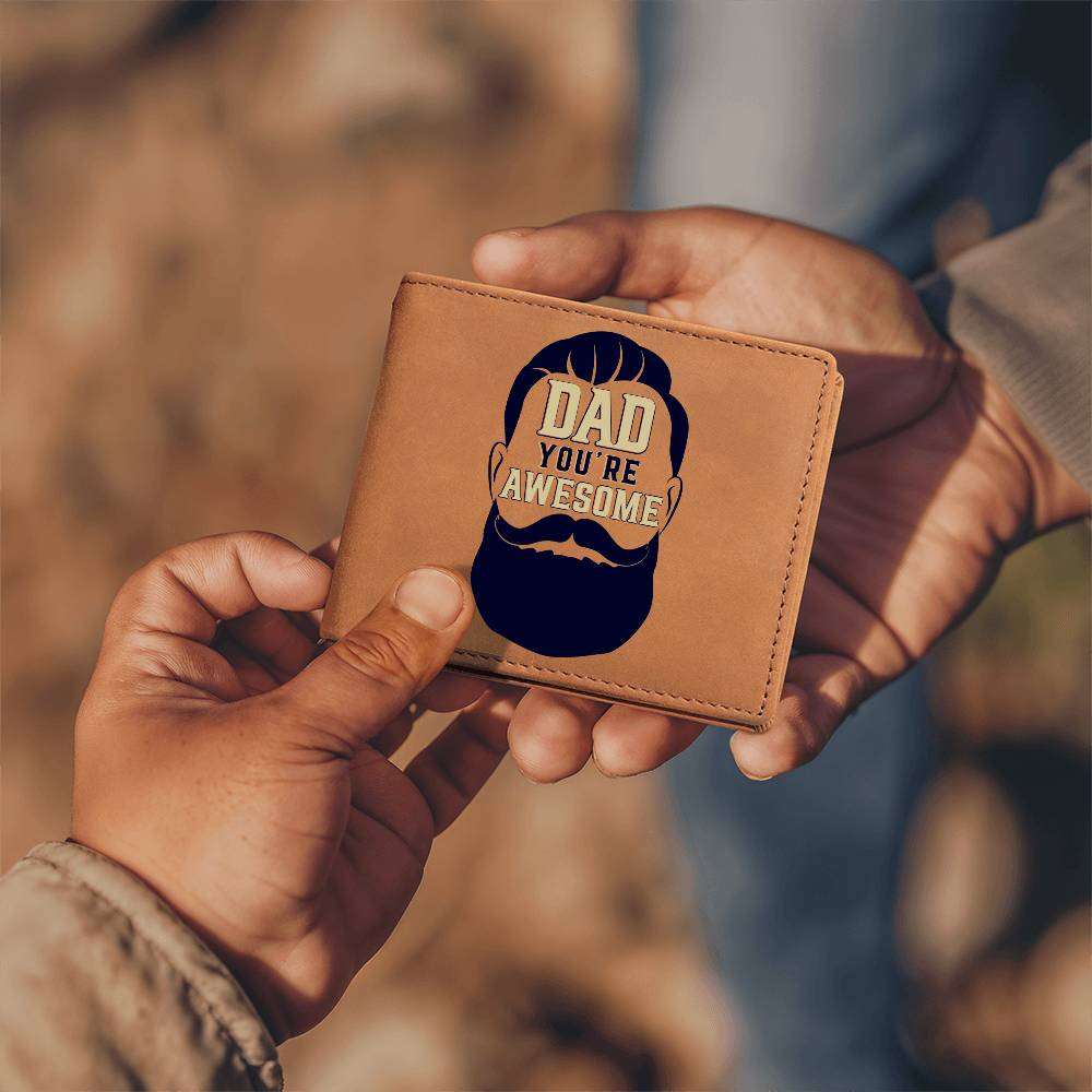 Leather wallet with "Dad You're Awesome" graphic design, held in hands, made of genuine full grain cowhide.