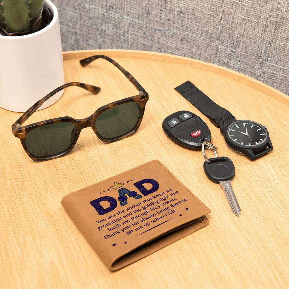 Leather wallet with "Dad You Are The Anchor" design on wooden table with sunglasses, car key, and watch.