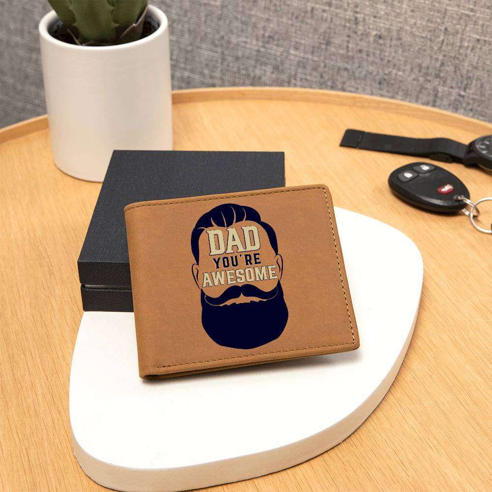 Leather wallet with "Dad You're Awesome" graphic displayed on wooden table.