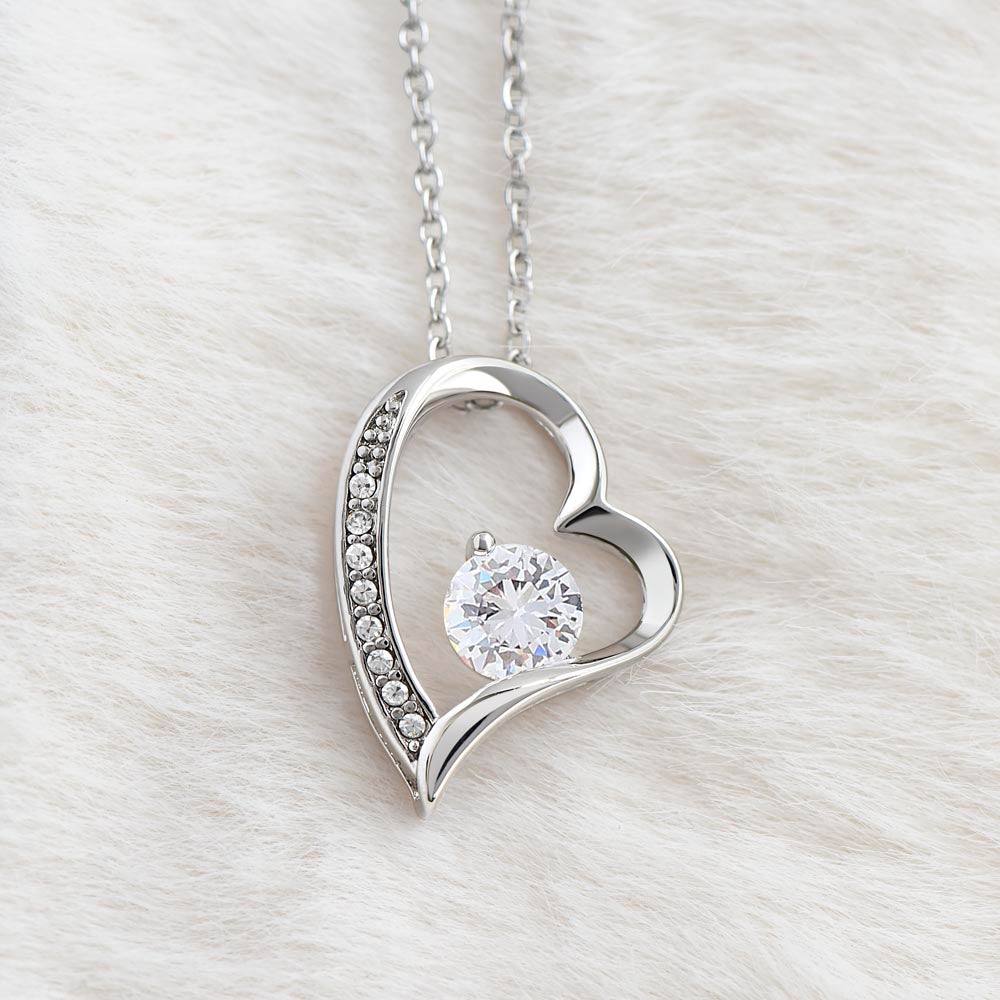 Heart necklace for wife with cubic zirconia and crystal accents, available in white or yellow gold finish.