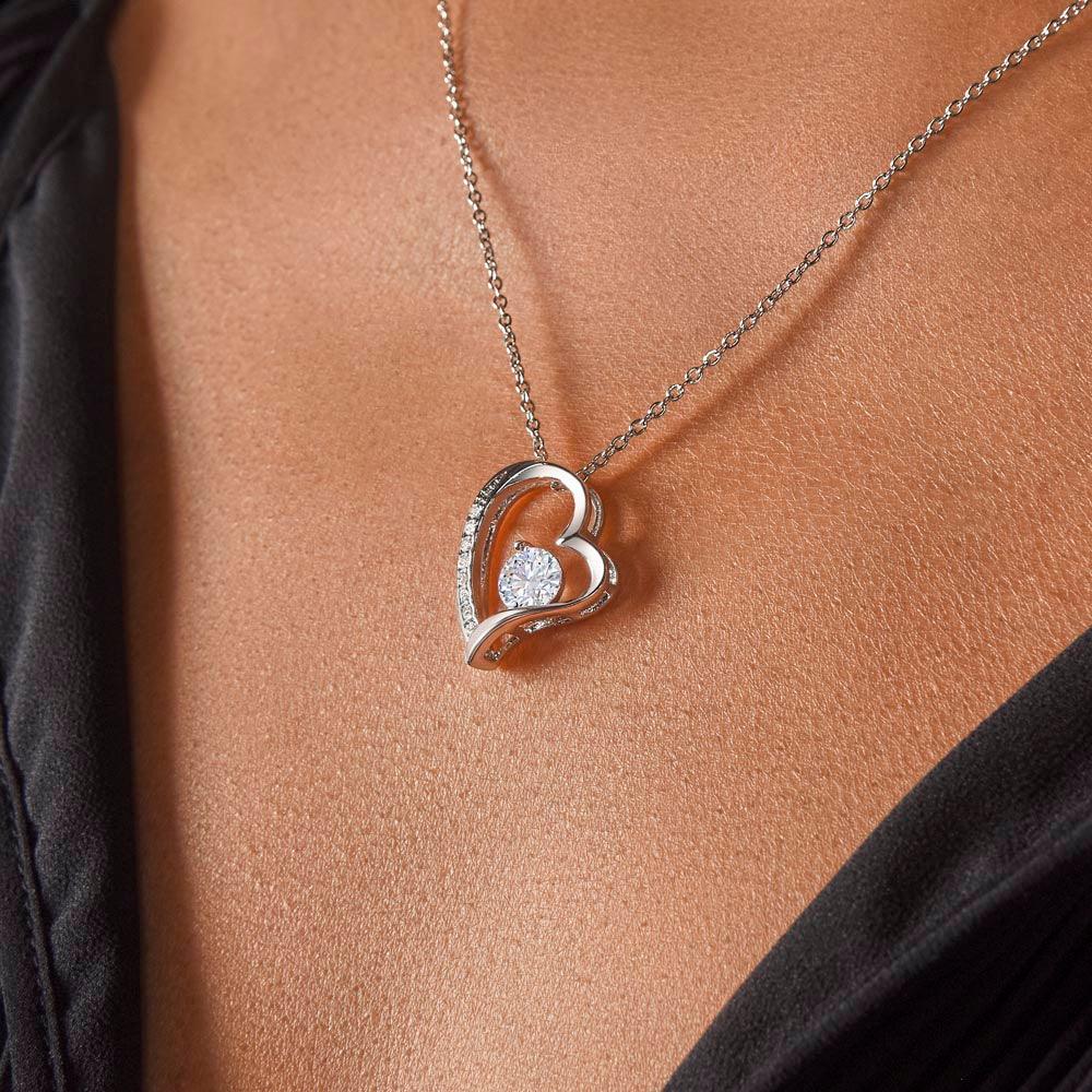 Heart-shaped necklace with cubic zirconia, worn by a person; perfect gift for wife.